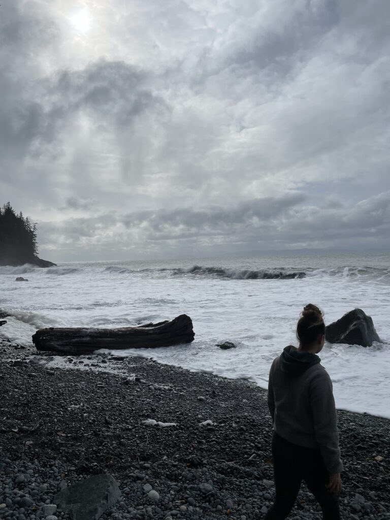 Broke walking in front of the slashing waves.