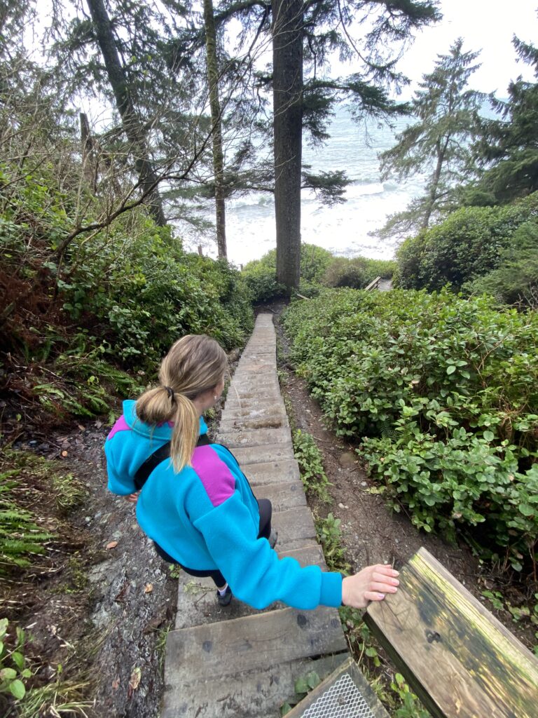 Jenna walking down the long flight of steps to the beach.