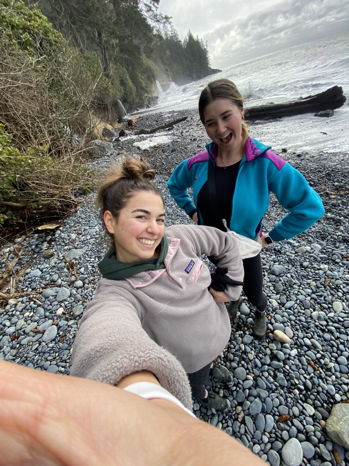 Selfie of Jenna and I. We are posing with the waves in the background.